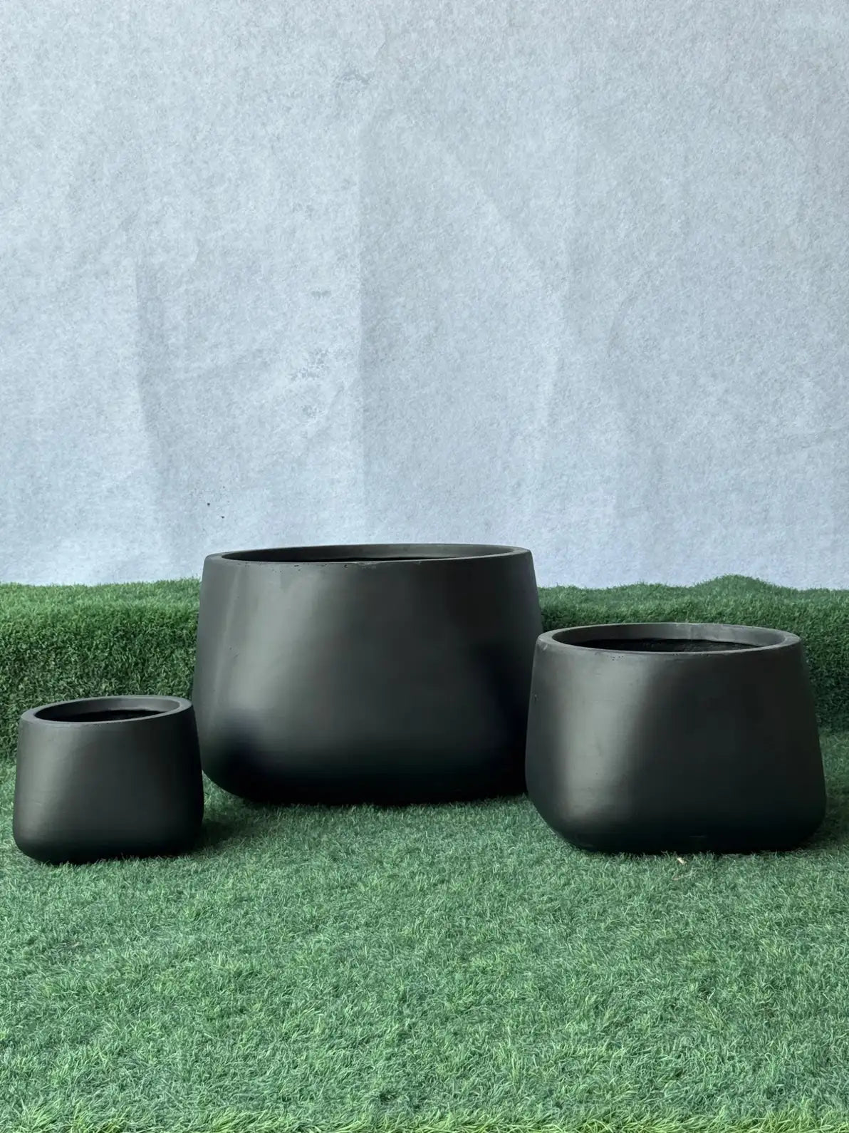 Round Matte Black Fiber Pots, luxurious handcrafted planters for indoor and outdoor plants in Dubai.